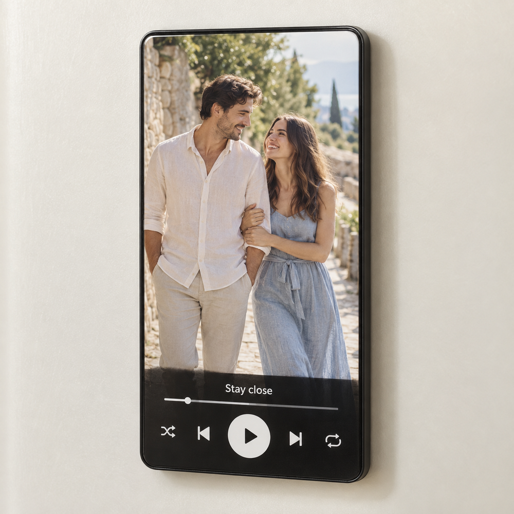 Tall black rectangular music fridge magnet with a couple photo and original white play button.