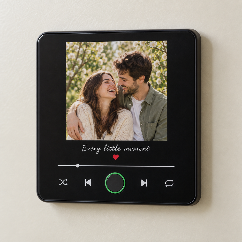 Black album-style photo music fridge magnet with a couple portrait and blank green-ringed button.
