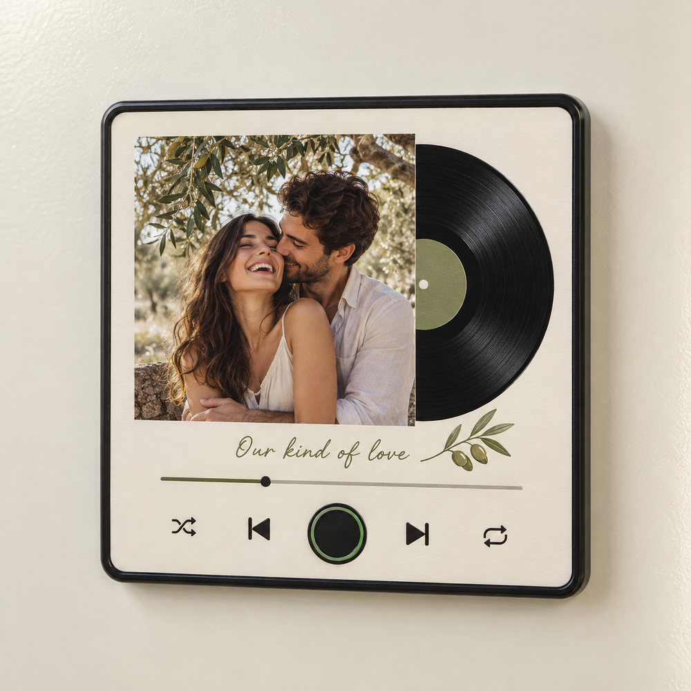 Cream album-art music fridge magnet with a couple photo, flat printed record motif and blank green-ringed control.