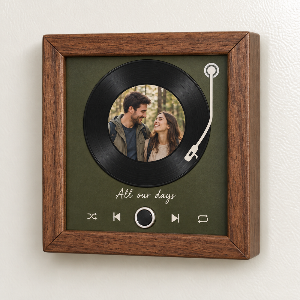Walnut framed music fridge magnet with a printed record motif, couple portrait and silver-ringed control.