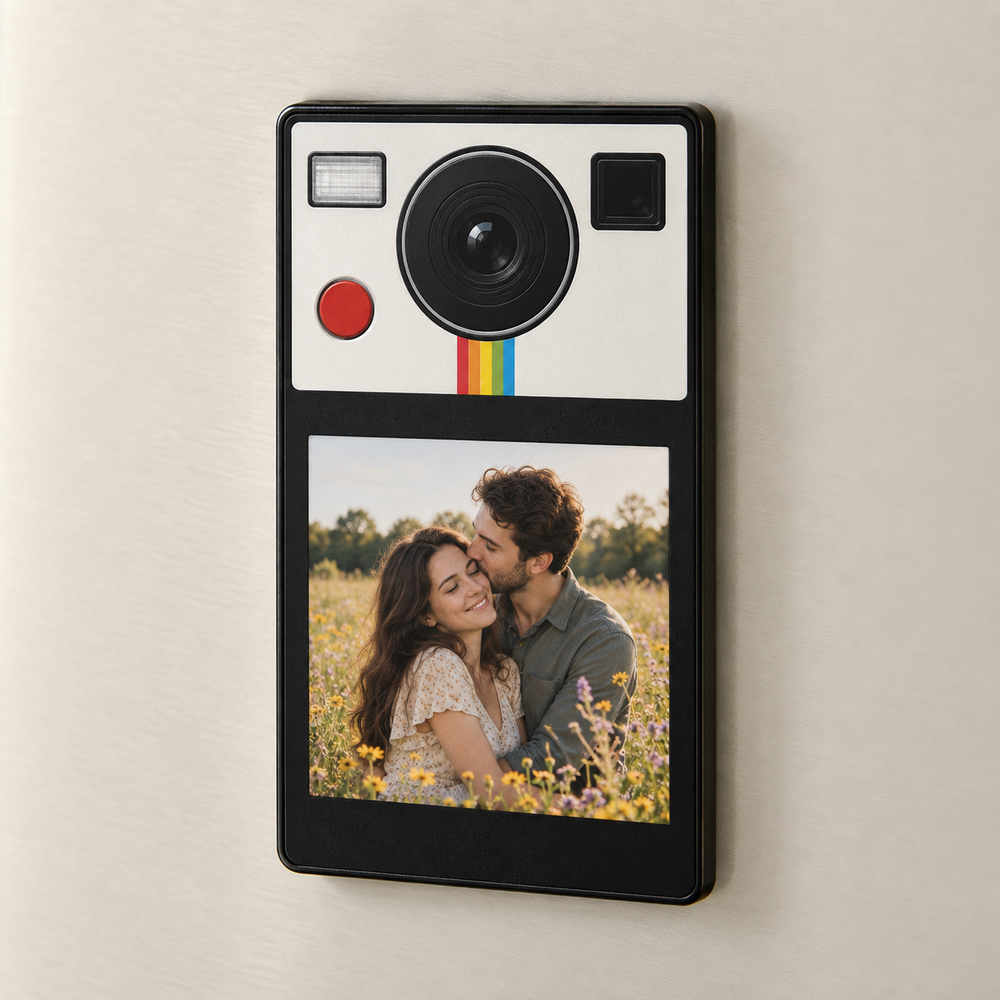 Tall black photo fridge magnet with a printed instant-camera design and a couple in a wildflower field.