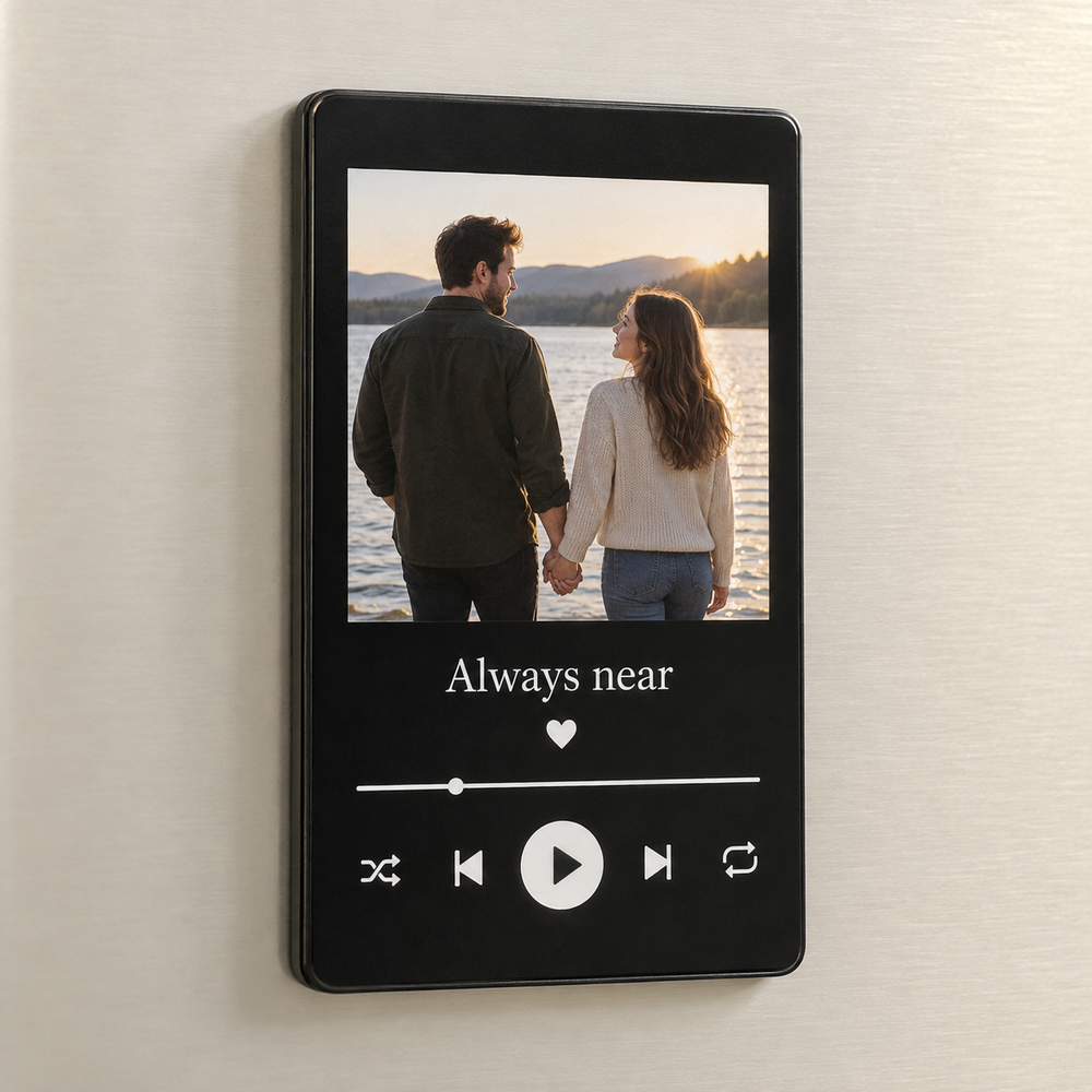 Tall black music fridge magnet with a lakeside couple photo, Always near caption and white play button.